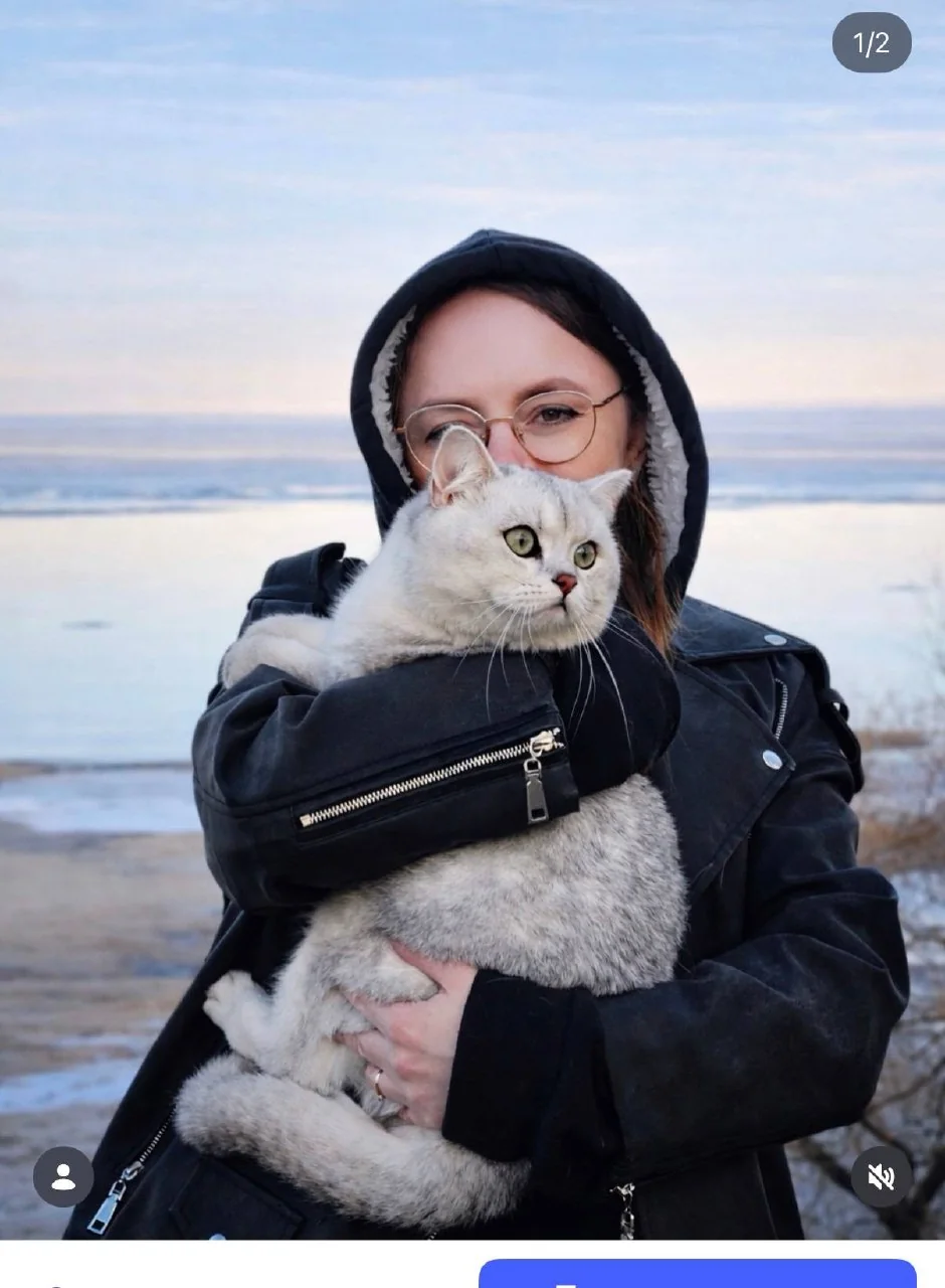 The person who created IRBIS Sudoku holding Irbis the cat by the sea.